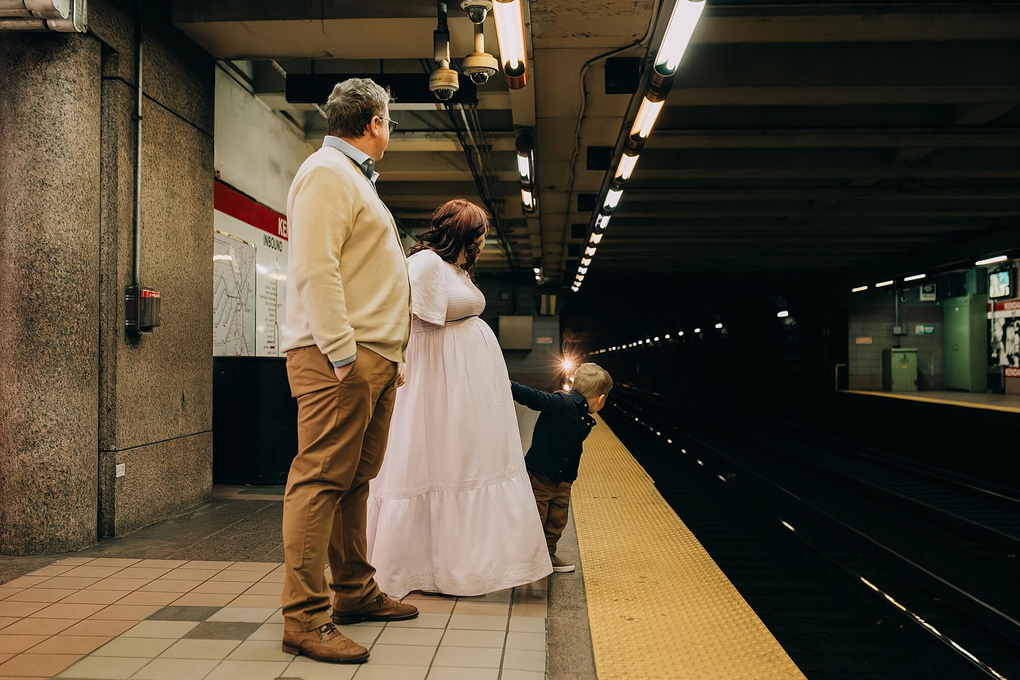 A family waits for the train at Kendall Station in Boston