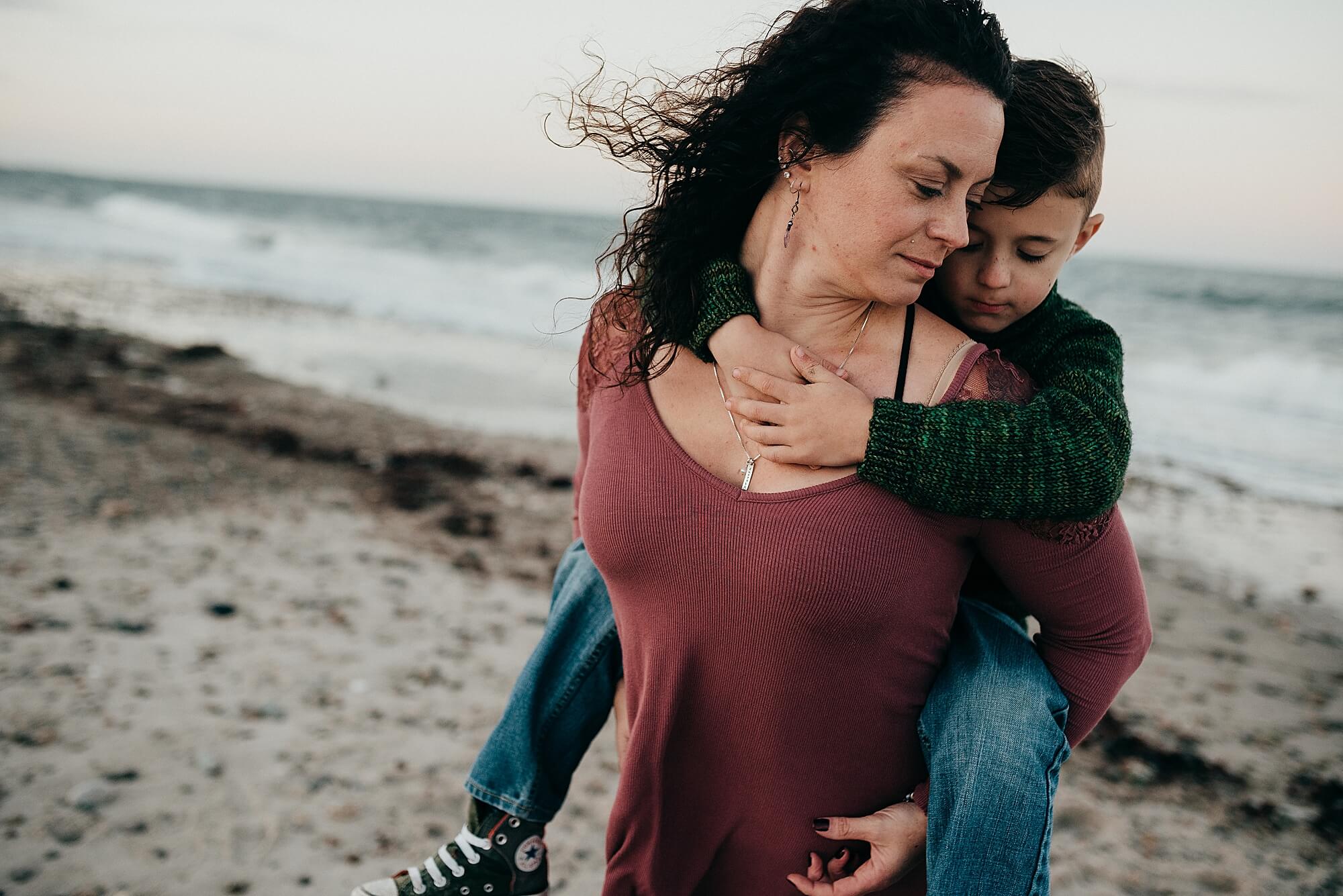 A mother gives her young son a piggy back ride