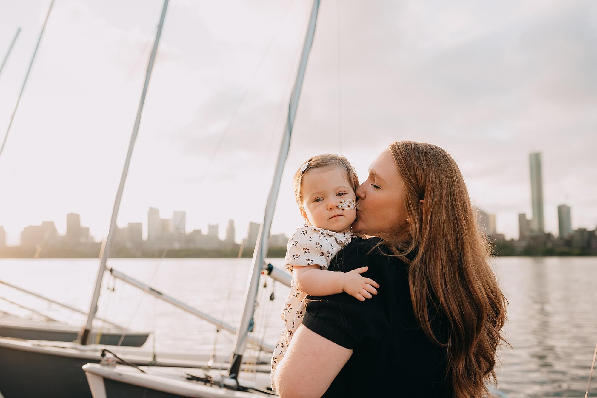 A mother kisses her daughter's cheek in Boston in the morning