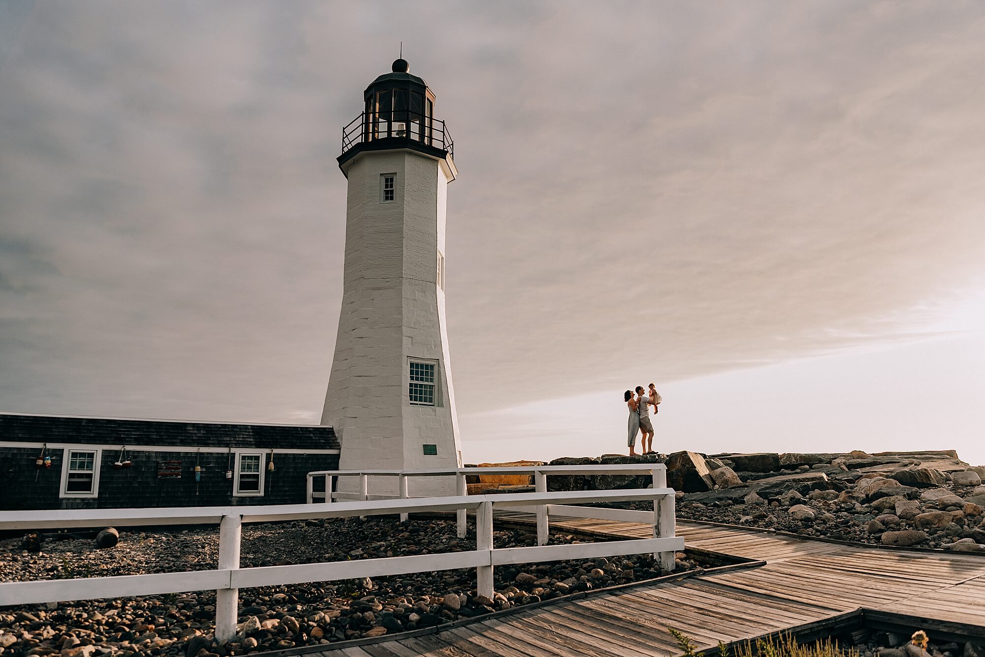 Family next to Scituate Lighthouse at Sunrise