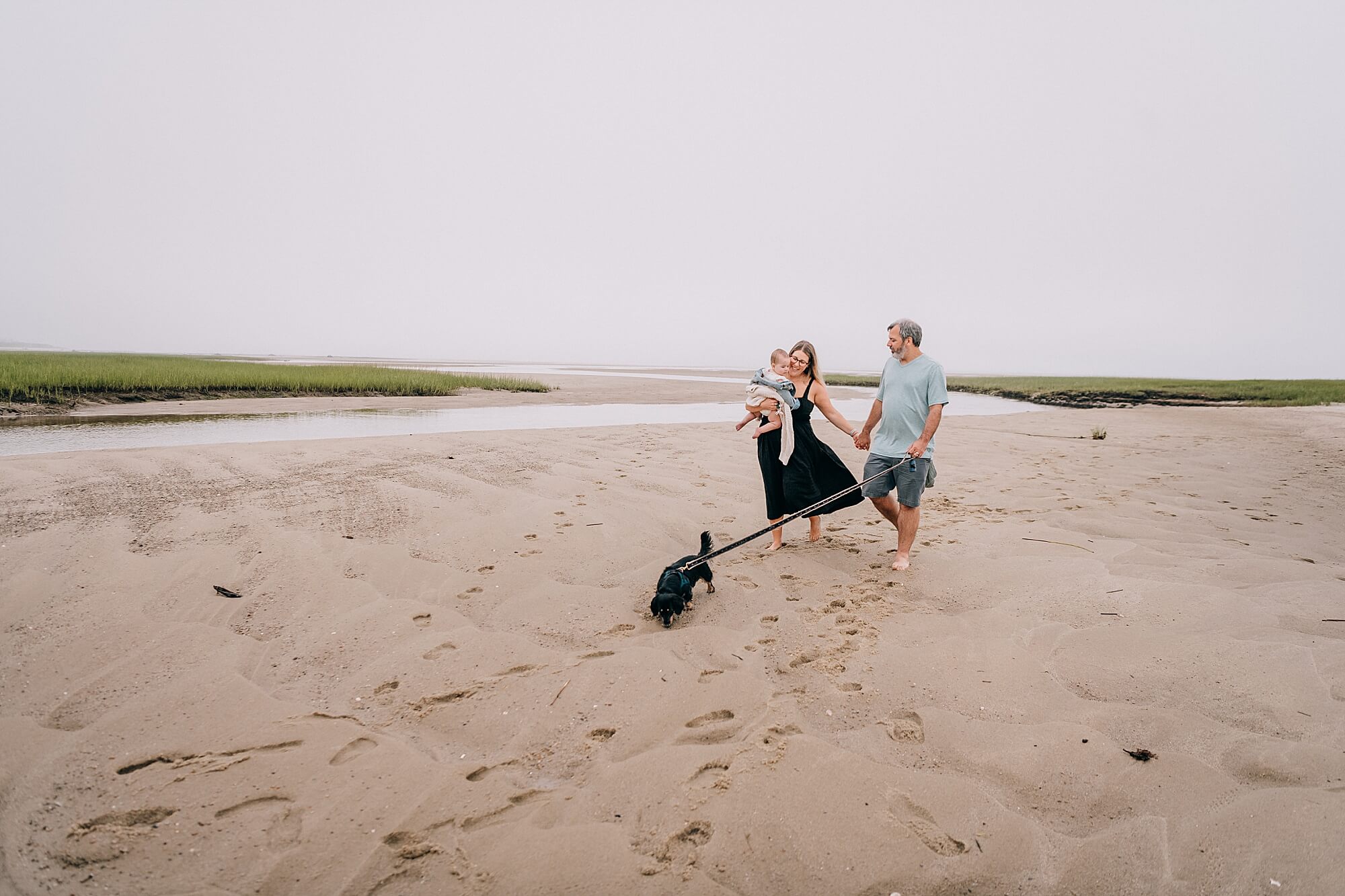 Family walks along the beach in Brewster MA
