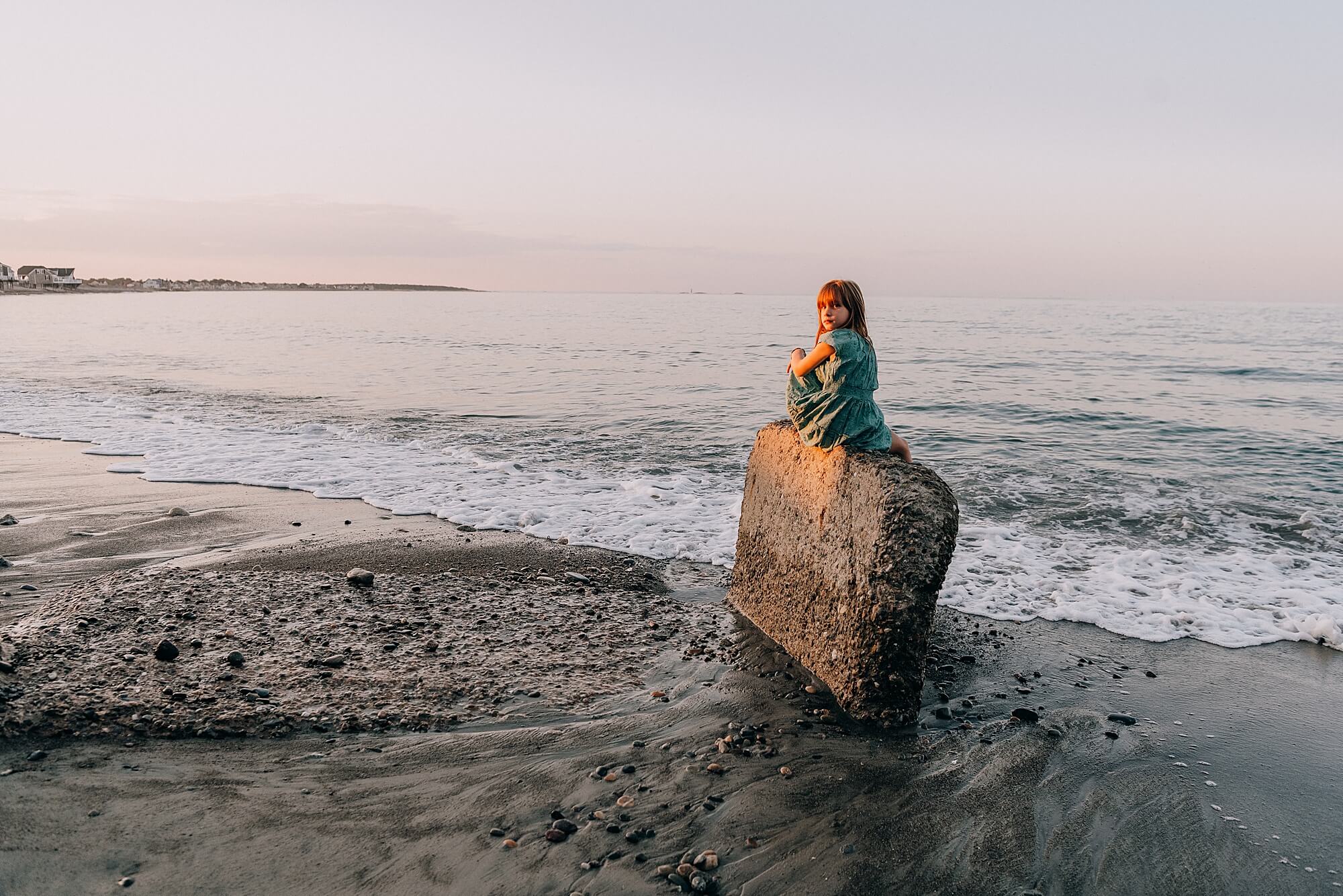 Girl sits on a rock at Egypt beach during a session with Scituate MA Family Photographer Allison Wolf